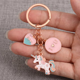 Licorne porte-clé présentée dans une main, avec cœur BFF rose et turquoise et médaille I love you