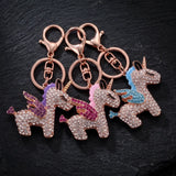Trois porte-clés licorne ailée ornés de strass, avec ailes roses, bleues et violettes