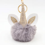Porte-clé licorne pompon gris avec corne dorée pailletée