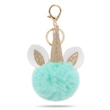 Porte-clé licorne pompon turquoise avec anneau et mousqueton dorés
