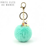 Porte-clés licorne pompon turquoise sur fond blanc, accessoire féerique lumineux pour sac ou clés