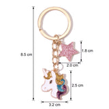 Porte-clé tête de licorne étoilé, longueur totale de 8,5 cm, tête de 3,2 × 2,5 cm et étoile de 2 × 1,8 cm