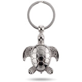 Porte clé tortue argent en métal sur fond blanc