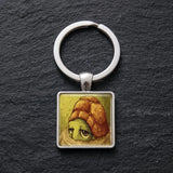 Porte clé tortue cabochon avec illustration de tortue sur fond noir