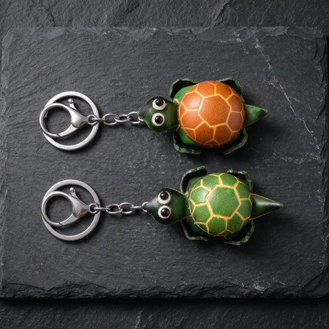 Porte clés tortue cuir en forme de tortue avec deux coloris vert et orange sur fond ardoise