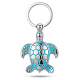 Porte clé tortue original phosphorescent en métal argenté sur fond blanc