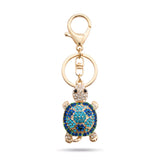 Porte clé tortue zircon bleu et doré à strass sur fond blanc