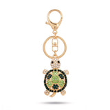 Porte clé tortue zircon vert et doré à strass sur fond blanc