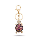 Porte clé tortue zircon violet et doré à strass sur fond blanc