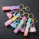 Quatre porte-clés licorne bulle transparents remplis de décorations colorées