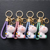 Porte-clés licorne Crochet en quatre coloris : violet, rose, bleu et vert menthe, avec lanières tressées