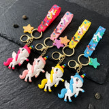 Porte-clés licorne en quatre coloris : rose vif, rose pastel, jaune et bleu, avec lanières décorées et étoiles